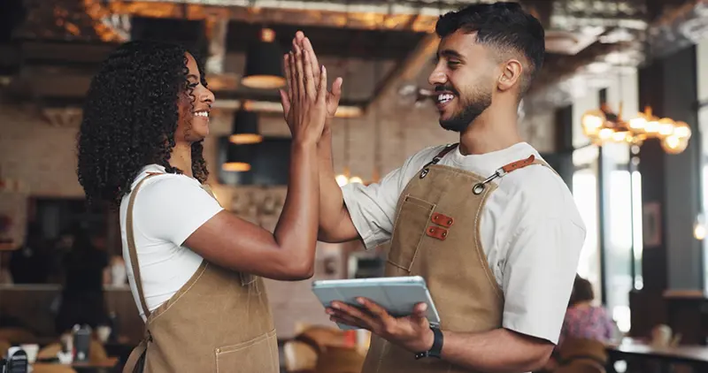 Deux restaurateurs célébrant la réussite de l'installation de leur nouveau logiciel de caisse Clyo Systems